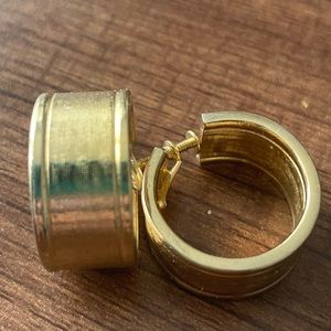 Vintage Coro hoop screw-on earrings in gold. Body of earrings is textured. Heavy